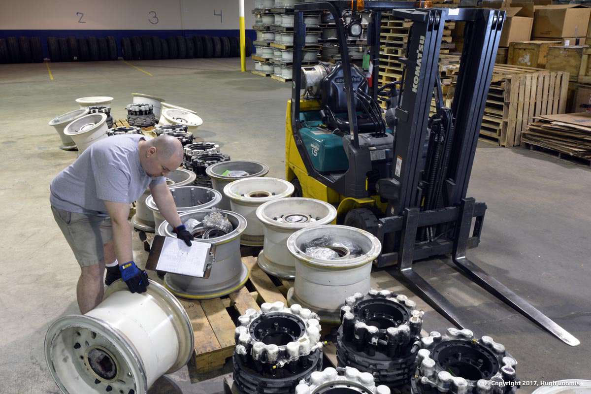 Employee arranges aircraft wheels inside of our warehouse