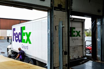 A FedEx truck in the loading dock receiving shipments of aircraft wheels and brakes